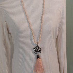 2953 Plunder Long Cream Color Beaded Necklace With A Ribbon Embellished Pendent.